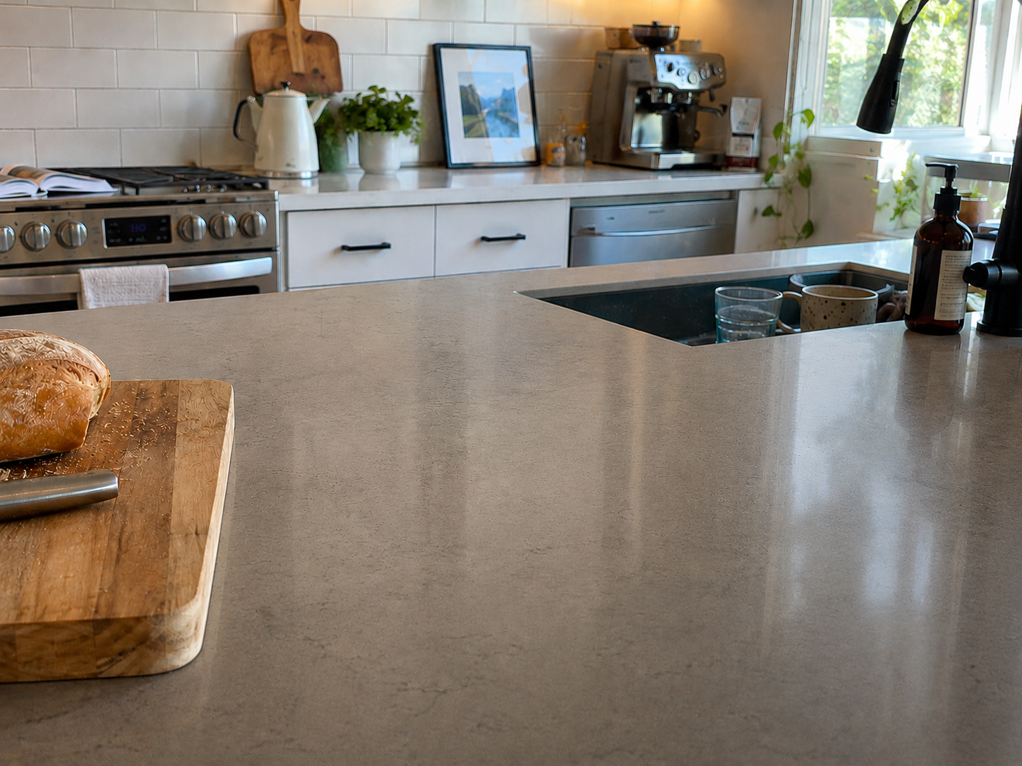 Modern kitchen with concrete countertop, stove, and sink.